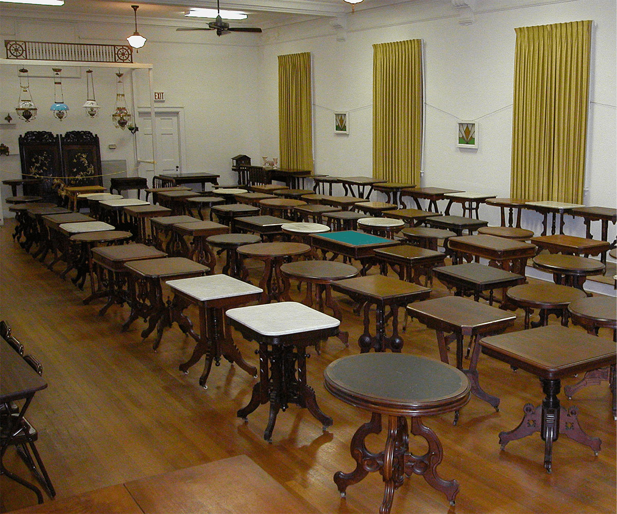 A large room filled with Victorian wood furniture