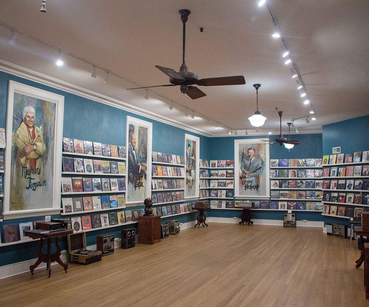 Photo of a room with shelves of vintage records and large photos of Jazz musicians