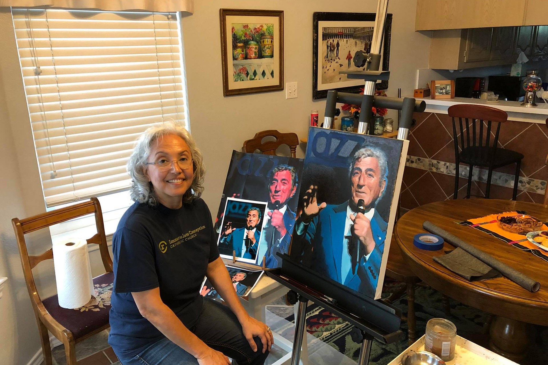 Diana Jelen seated beside her in-progress portrait of Tony Bennett
